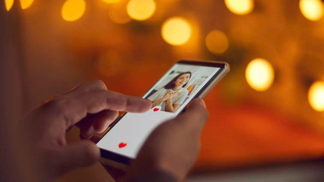 A woman using a dating app on her smartphone